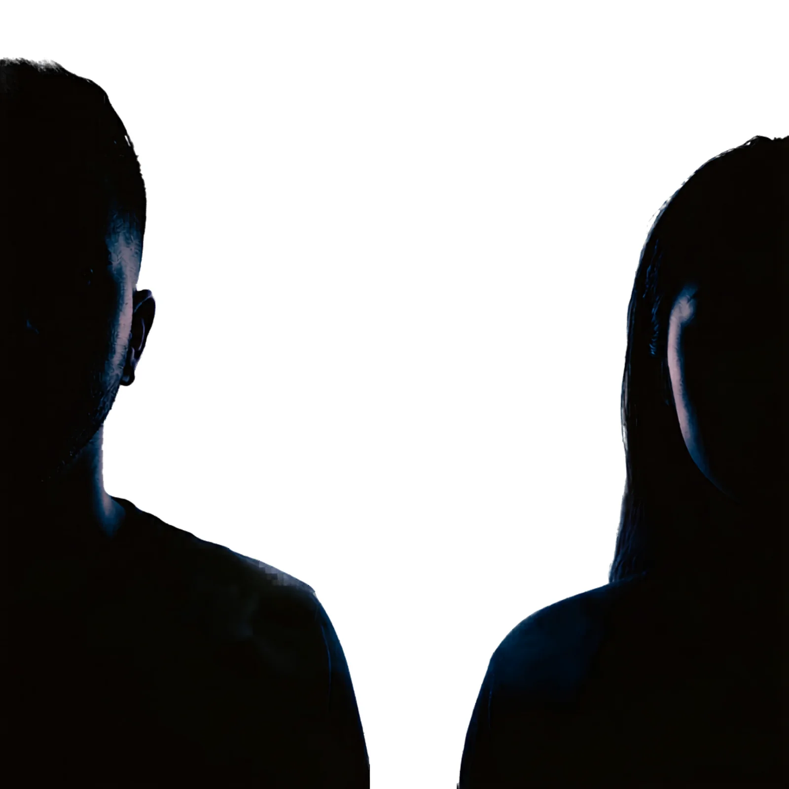 Two shadowed human silhouettes looking toward a bright source of light.